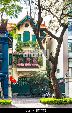 Traditional French styled house with shuttered windows and ornamental decorative flowers, Old Quarter, Hanoi, Vietnam, Asia Stock Photo