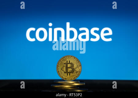 Bitcoin on a stack of coins with Coinbase logo on a laptop screen. Cryptocurrency and blockchain adoption getting mainstream. Slovenia - 02 24 2019 Stock Photo