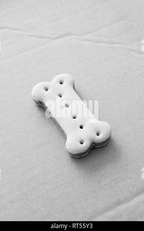 Bone shaped dry pet dog food on a cardboard box Stock Photo