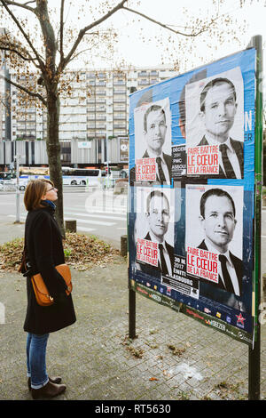 STRASBOURG, FRANCE - DEC 9, 2016: Young French woman admiring the electoral posters of Benoit Hamon candidate for the presidency in France Stock Photo