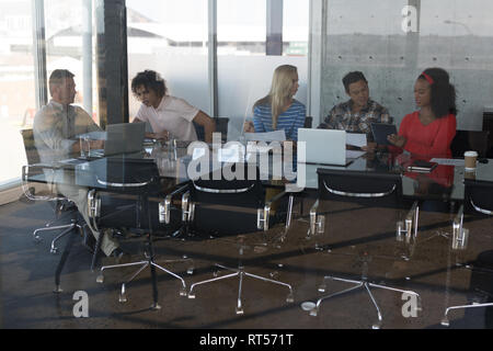 Executives working at table in office Stock Photo