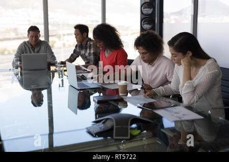 Executives working at table in office Stock Photo