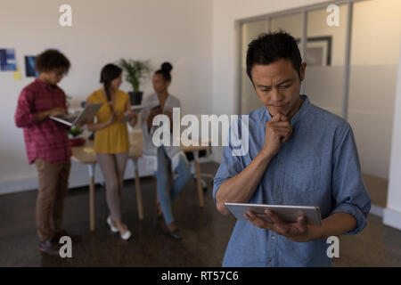 Male executive using digital tablet in office Stock Photo