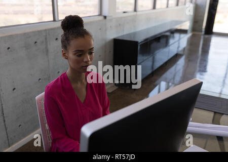 Female executive working on personal computer at desk Stock Photo