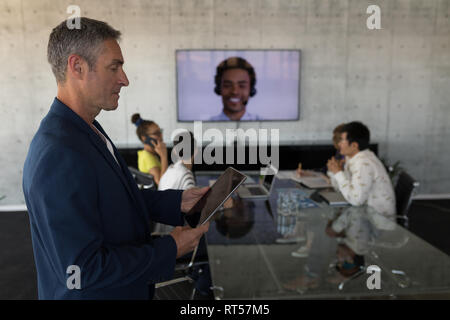 Business team working together on a video call in board room Stock Photo