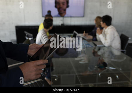 Businessman using digital tablet in office Stock Photo