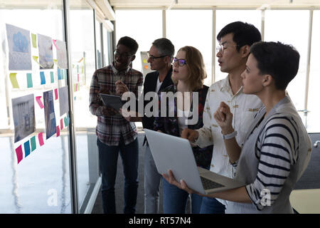 Business colleagues discussing over chart in office Stock Photo