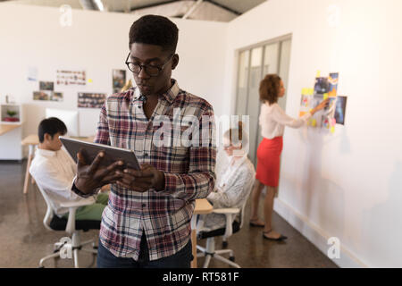 Male executive using digital tablet in office Stock Photo