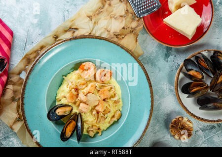 photo of delicious risotto with saffron and seafood on table Stock Photo