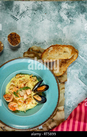 photo of delicious risotto with saffron and seafood on table Stock Photo