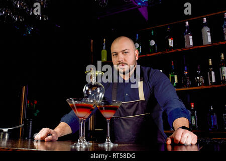 The pyramid of cocktails on the bar on a blurred background of the restaurant Stock Photo