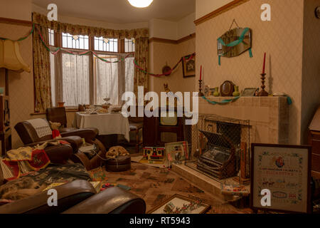 A British living room from the 1950's decked out to celebrate a birthday, York Castle Museum, York, Yorkshire, UK. Stock Photo