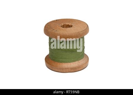 Wooden coil with sewing thread on a white background Stock Photo