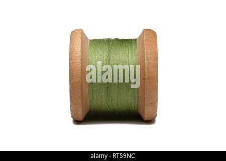 Wooden coil with sewing thread on a white background Stock Photo