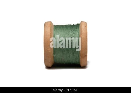 Wooden coil with sewing thread on a white background Stock Photo