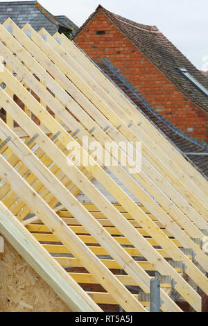 Detail of timber roof trusses on a new roof under construction Stock Photo