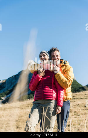 Austria, Tyrol, happy couple embracing on a hiking trip in the mountains Stock Photo