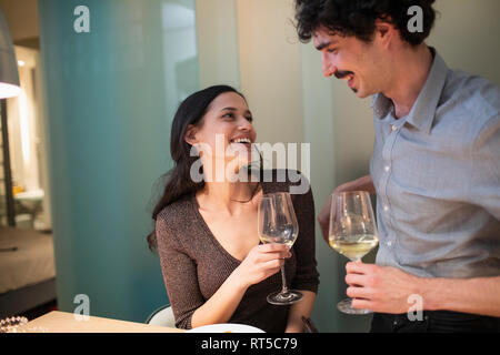 Happy couple drinking white wine Stock Photo