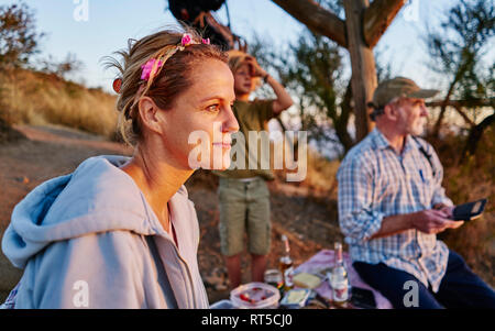 Chile, Santiago, mother with grandfather and son having a picnic at sunset Stock Photo