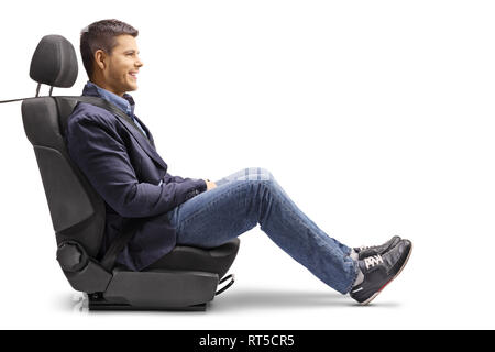 Full length profile shot of a young man in a car seat with a fastened seatbelt isolated on white background Stock Photo