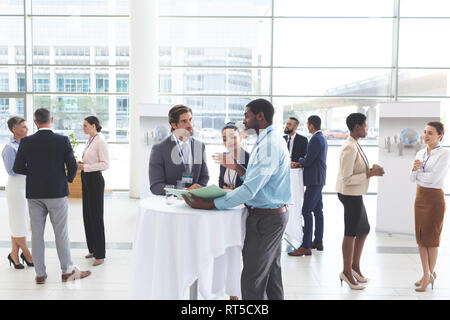 Business people discussing over documents at table during a seminar Stock Photo