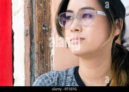 Portrait of young woman wearing fashionable glasses Stock Photo