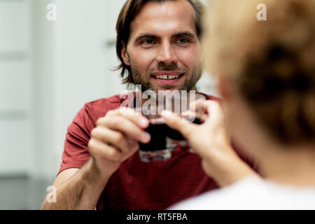 Happy couple toasting with redwine Stock Photo