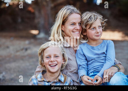 Portrait of happy mother with two sons outdoors Stock Photo