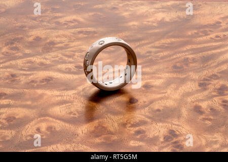 Silver ring on Mandora wood grain Stock Photo
