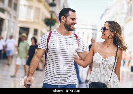 Spain, Andalusia, Malaga, happy tourist couple walking in the city Stock Photo