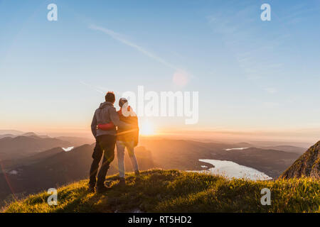 Austria, Salzkammergut, Couple standing on mountain summit, enjoying the view Stock Photo