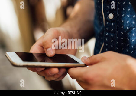 Man' hands using smartphone, close-up Stock Photo