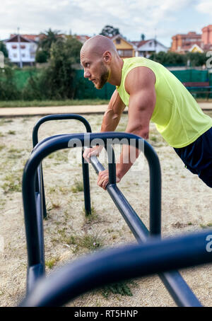 Muscular man exercising outdoors Stock Photo