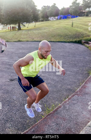 Muscular man exercising outdoors Stock Photo