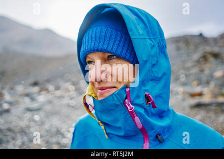 Argentina, Patagonia, El Chalten, portrait of woman in raincoat at Cerro Torre in Los Glaciares National park Stock Photo