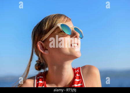 Croatia, Lokva Rogoznica, portrait of sunbathing girl on the beach wearing sunglasses