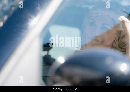 Annoyed blond woman in car Stock Photo