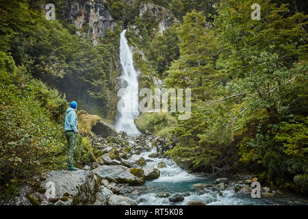 Chile, Laguna San Rafael National Park, woman admiring Las Cascadas waterfall Stock Photo