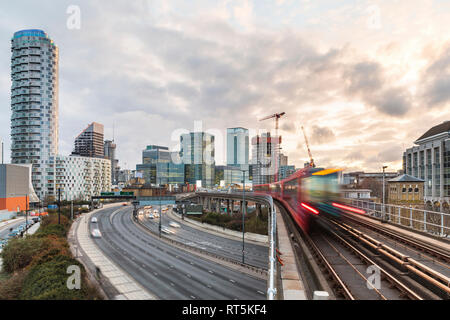 United Kingdom, England, London, inancial district with busy road and blurred metro train on foreground Stock Photo