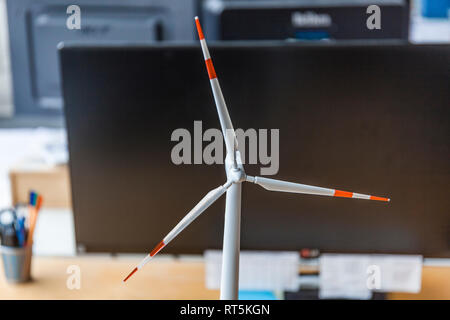 Close-up of wind turbine model and desktop computer in office Stock Photo