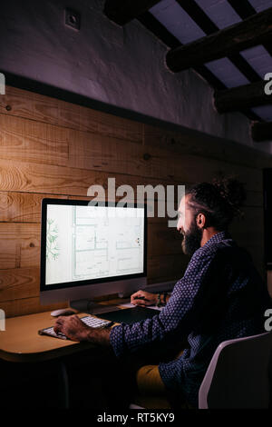 Young architect working hard on a new project at home at night Stock Photo