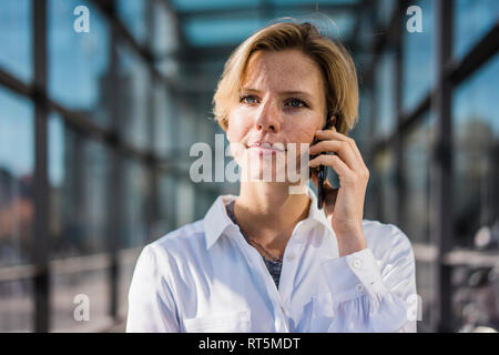 Young businesswoman using mobile phone Stock Photo