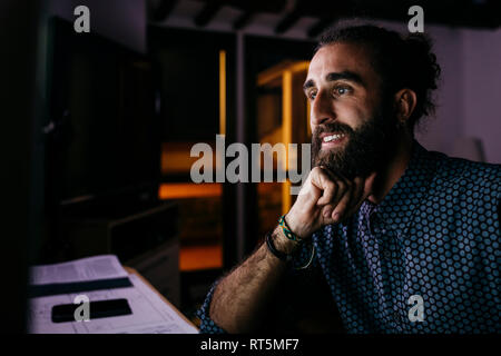 Young man working on a new project at home at night Stock Photo