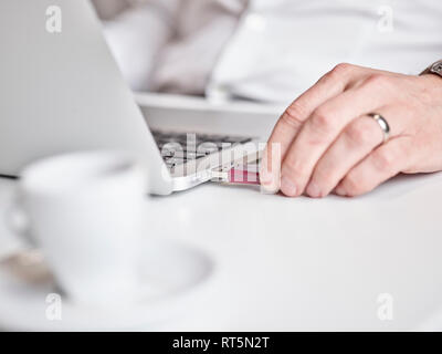 Close-up of man connecting usb stick to laptop Stock Photo