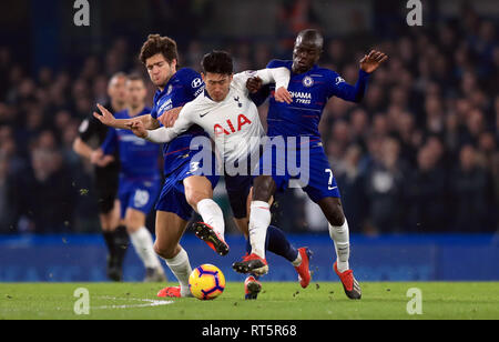 Tottenham Hotspur's Son Heung-min battles for the ball with Chelsea's Marcos Alonso (left) and N'Golo Kante (right) during the Premier League match at Stamford Bridge, London. Stock Photo