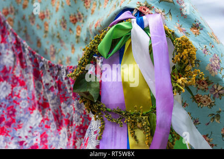 Bird's eye fabric tapestries, colorful ribbons and a wreath. Decorative background or pattern Stock Photo