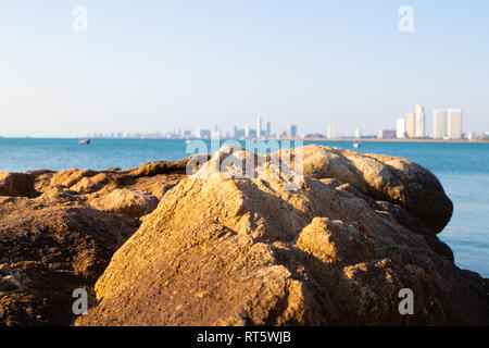 Panoramic view of Pattaya Thailand, coastline, rocky shore, promenade along sea, buildings, blue sky with white nice clouds. space for text Stock Photo