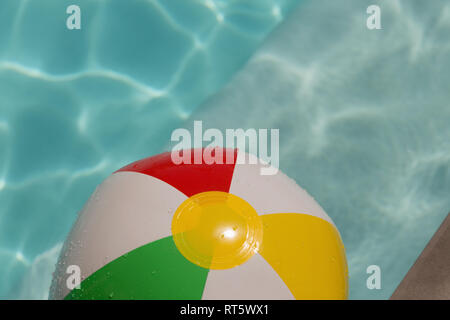 Inflatable ball floating in swimming pool Stock Photo