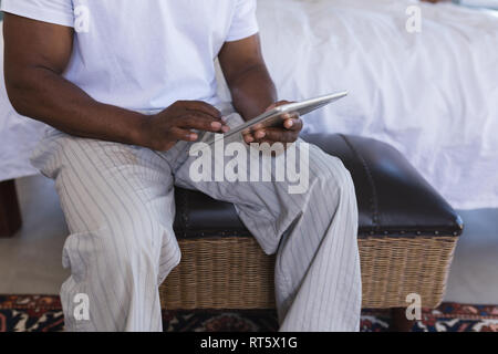 Senior man using digital tablet at home Stock Photo