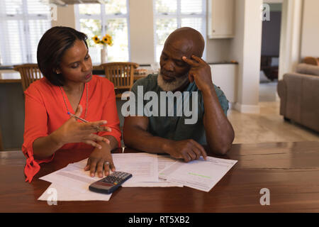 Senior couple discussing over invoices at home Stock Photo
